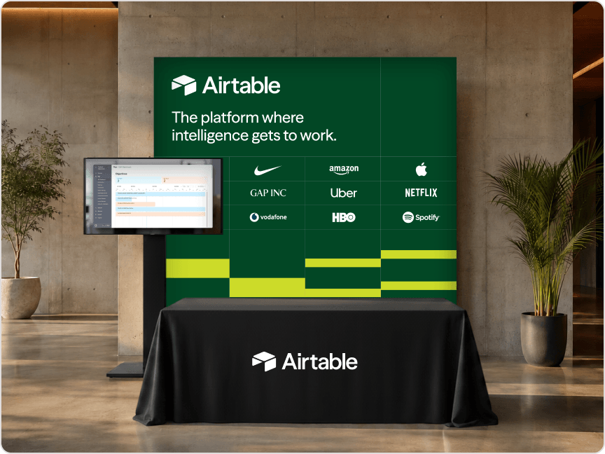Airtable booth package showing a branded backdrop, monitor, and table